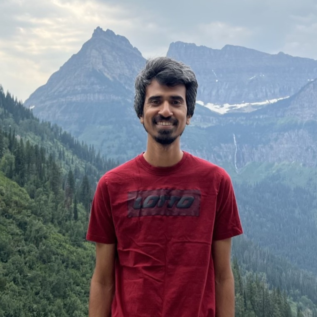 a photo of Mainul Islamin standing in front of a view of mountains in an Idaho state park